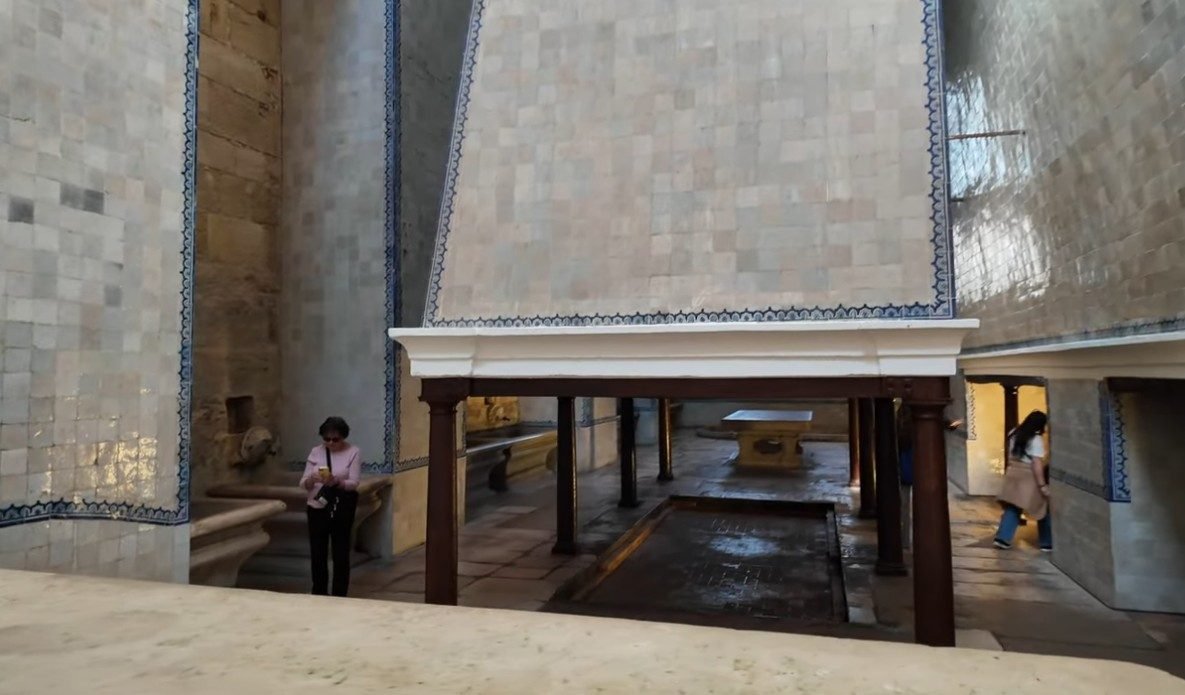 The Royal Kitchen of Alcobaça Monastery — the medieval channel of the River Alcoa diverted through the centre of the vast kitchen room, with its great chimney and stone counters, used continuously from the 13th to 19th century
