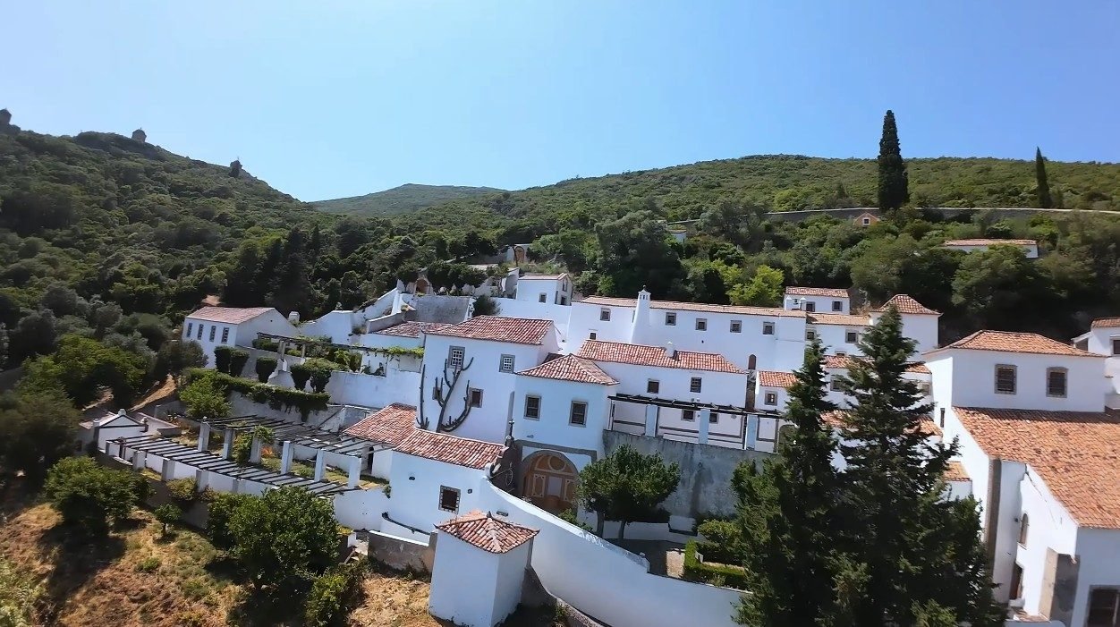 Convento da Arrábida — 16th-century Franciscan monastery clinging to the limestone cliff above the sea in Serra da Arrábida Natural Park
