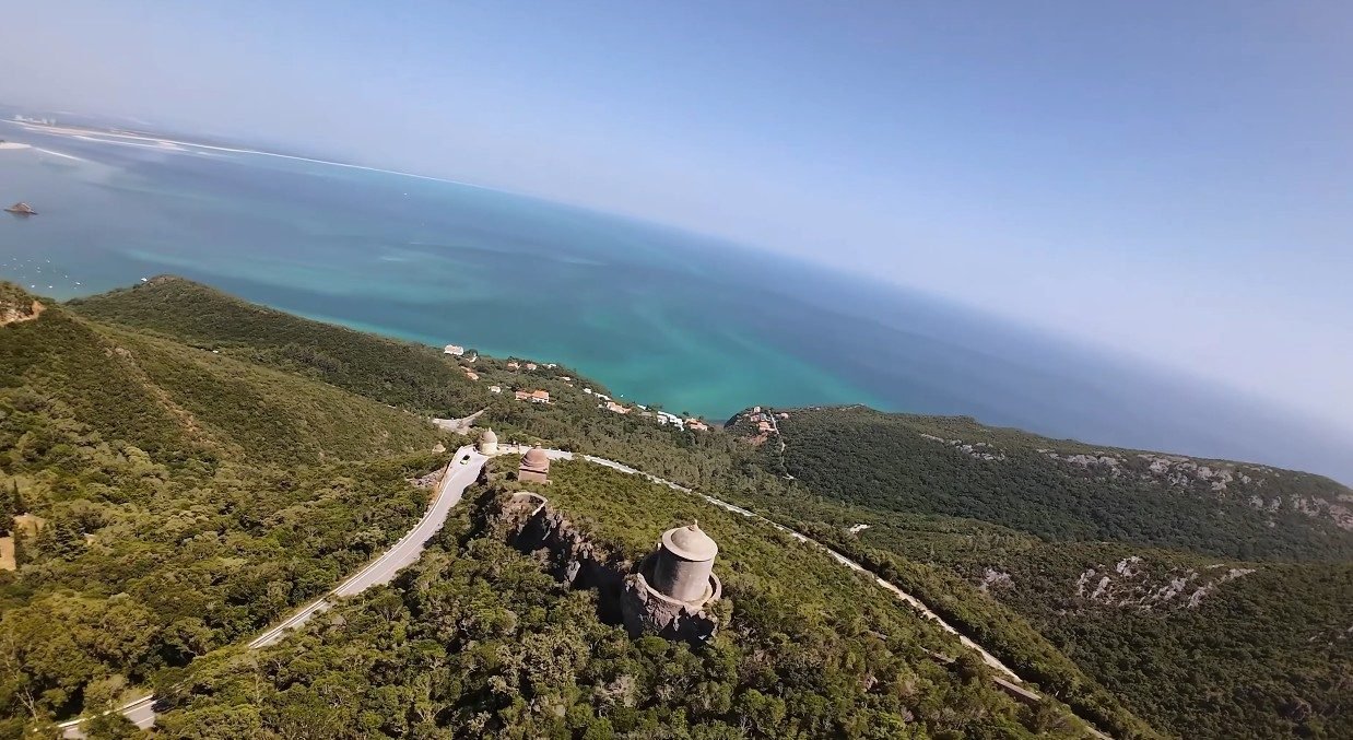 Panoramic view from the Serra da Arrábida ridge — limestone cliffs above turquoise water on a private nature and coast tour from Lisbon