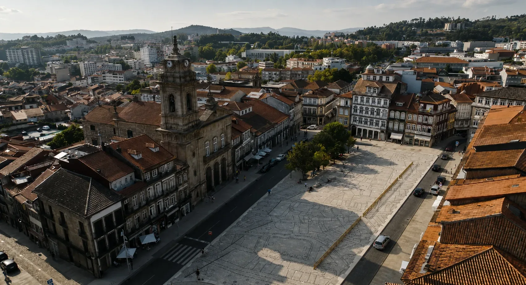 The medieval cobblestone streets of Guimarães UNESCO World Heritage historic centre — narrow granite-paved lanes flanked by 15th and 17th-century houses with painted wood balconies and whitewashed facades with yellow edging, one of the best-preserved medieval urban ensembles in the Iberian Peninsula