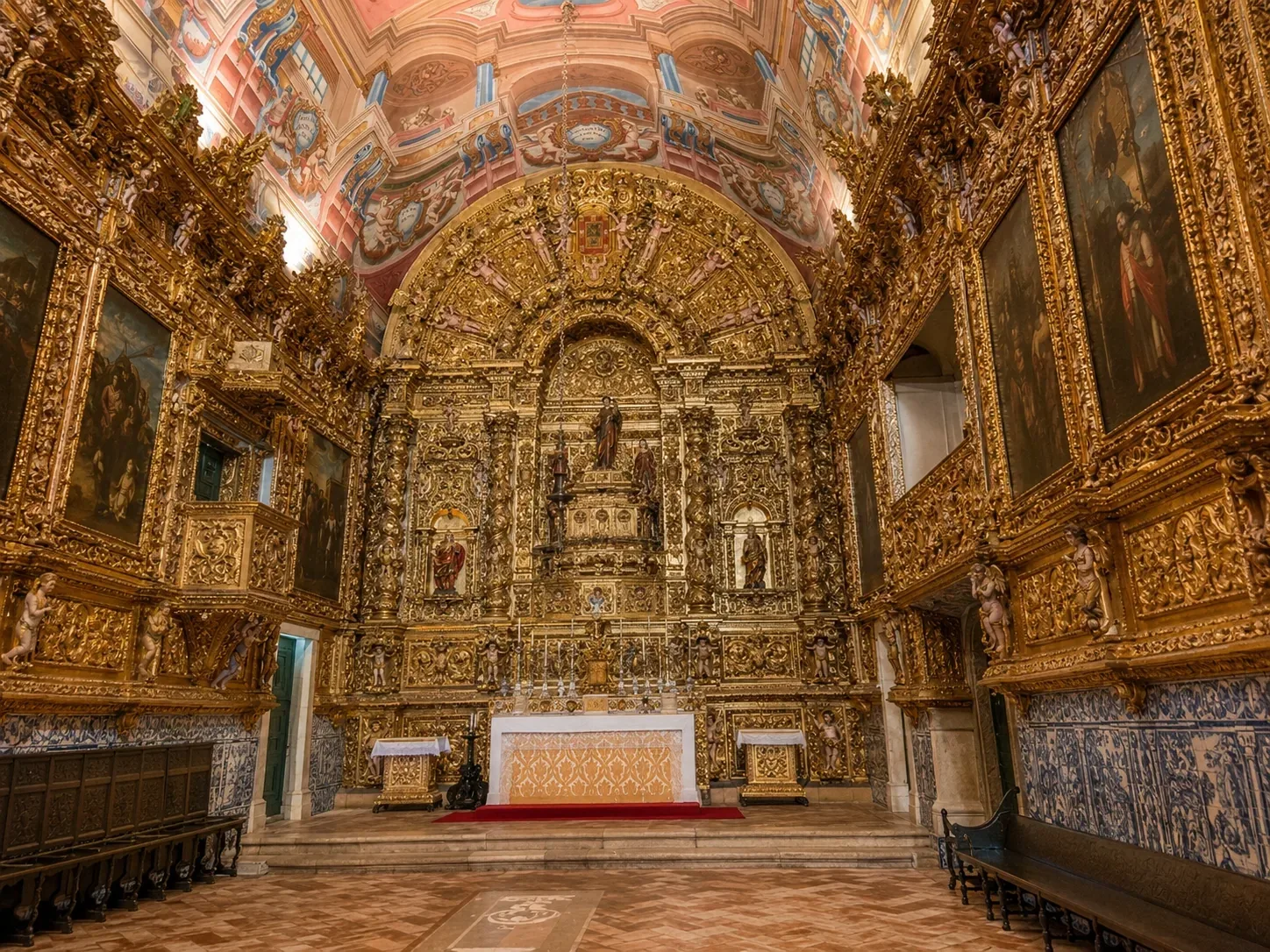The gilded Baroque interior of Igreja de Santo António in Lagos — floor-to-ceiling carved and gilded woodwork covering every surface of the 18th-century church interior, one of the finest examples of talha dourada gilded wood carving in the Algarve