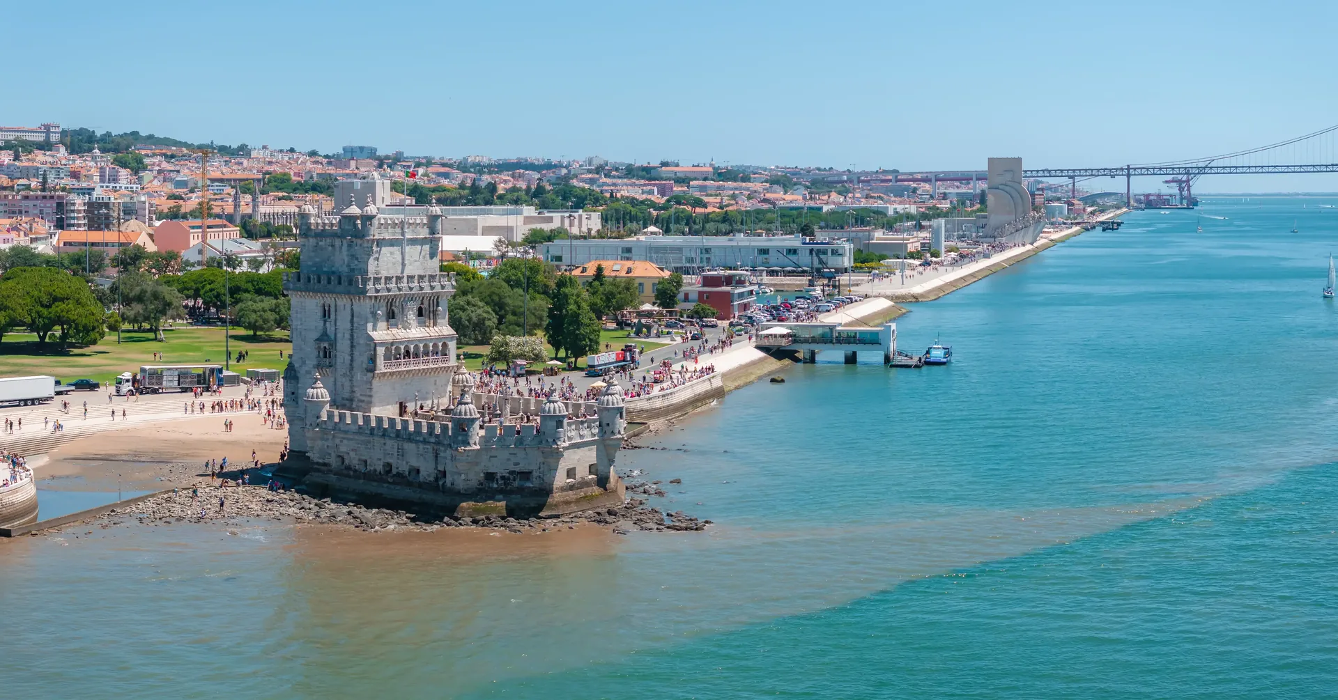 Torre de Belém rising from the Tagus shoreline in Belém, Lisbon — the 16th-century Manueline fortress tower that served as the ceremonial gateway to Lisbon for fleets returning from the Age of Discoveries, a UNESCO World Heritage Site seen on the private Lisbon full-day tour