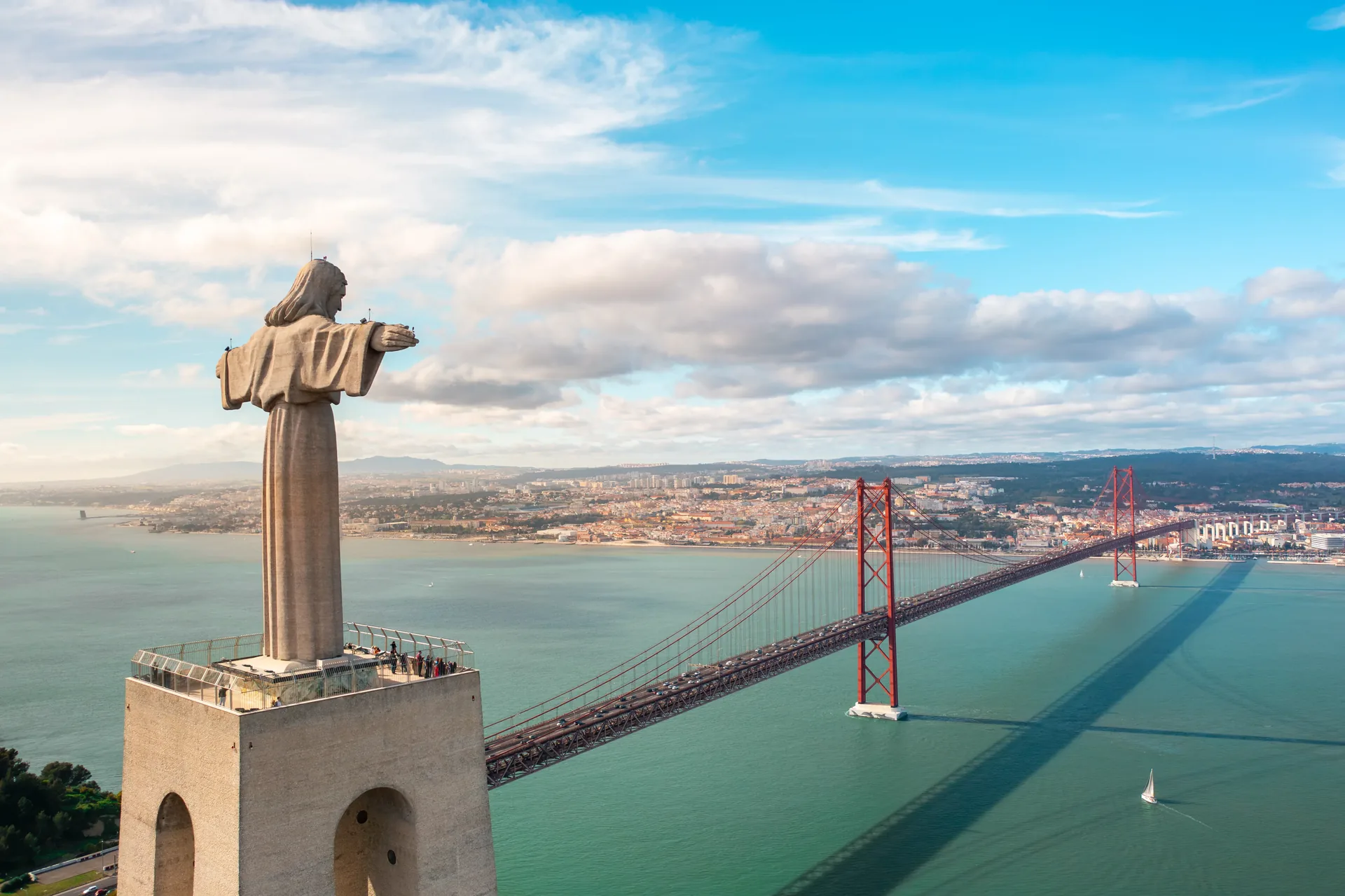 Sweeping panoramic view over Lisbon's terracotta rooftops, the Alfama district, and the Tagus River estuary from one of the city's secret hidden miradouro viewpoints — the kind of spot your private guide takes you that most tourists never discover