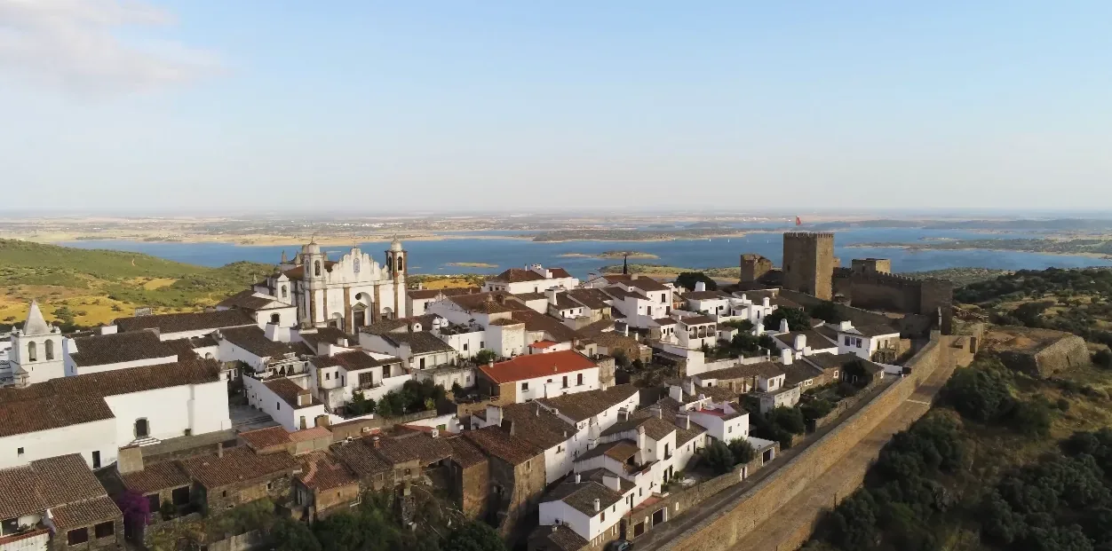 Monsaraz medieval hilltop village — white houses and narrow cobblestone lanes below the 13th-century castle walls
