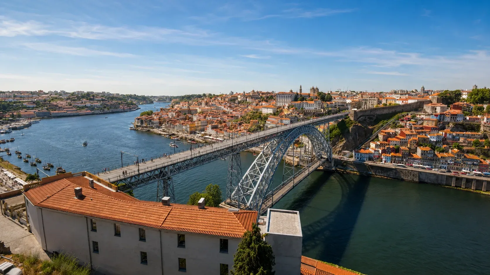 Panoramic view of Porto from the Serra do Pilar monastery terrace — the circular Renaissance cloister above Vila Nova de Gaia offering the finest elevated view across the entire historic centre of Porto, its bridges, and the Douro river winding to the Atlantic