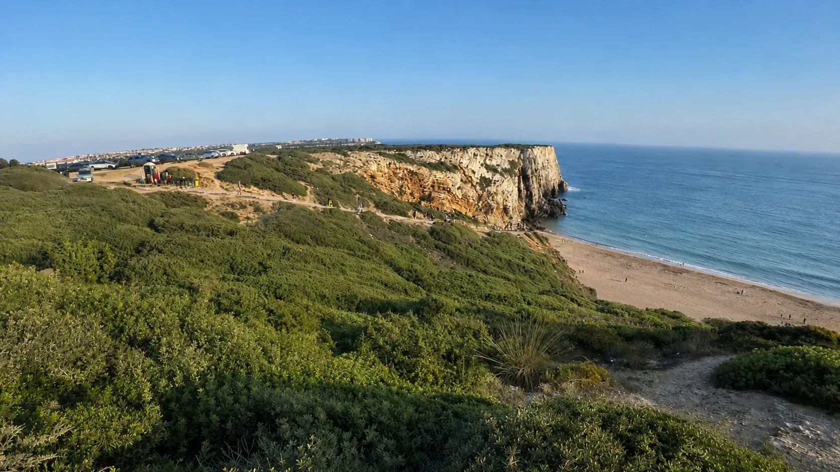 Praia do Beliche hidden cove below Cape St. Vincent — a small enclosed beach of golden sand tucked between dramatic Atlantic cliff walls just east of the cape, one of the most secluded and sheltered beaches on the western Algarve coastline