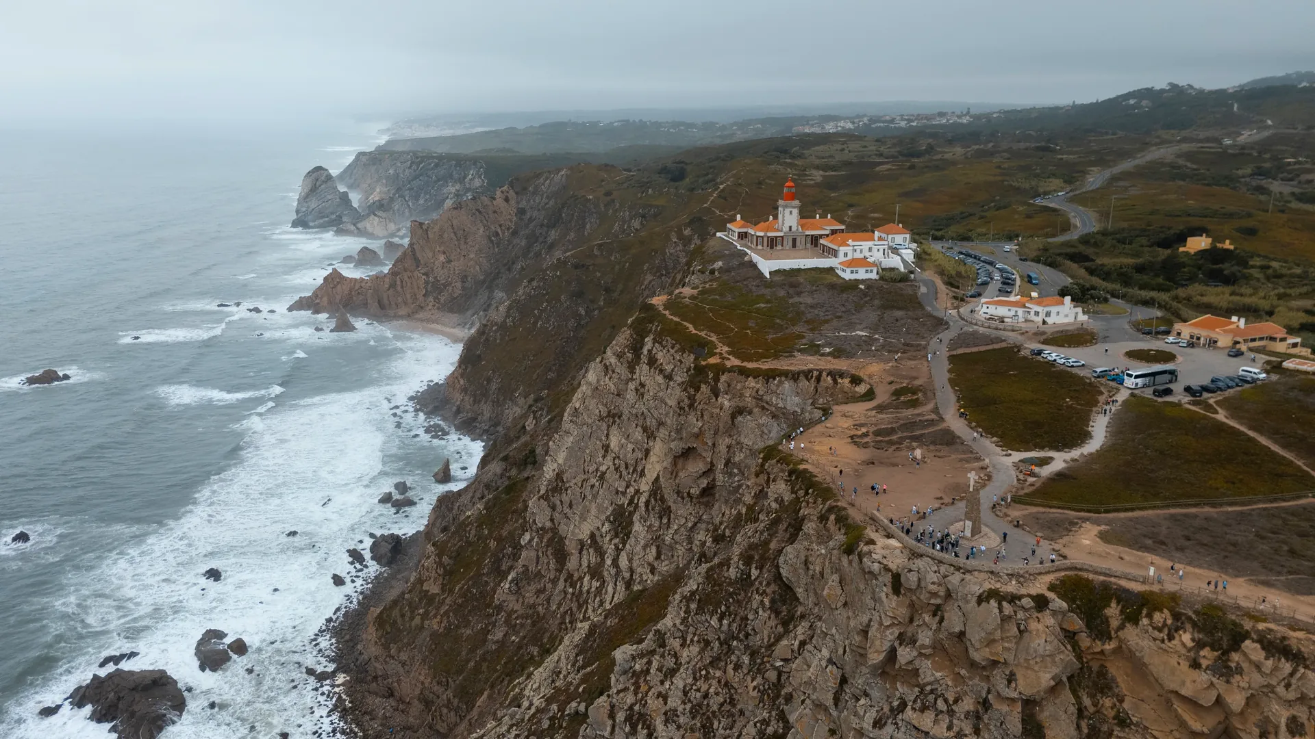 The cliff edge at Cabo da Roca, the westernmost point of continental Europe — 140 metres above the Atlantic Ocean on the Sintra coast, where Luís de Camões wrote 'here the land ends and the sea begins', visited on the private Sintra and Cascais tour