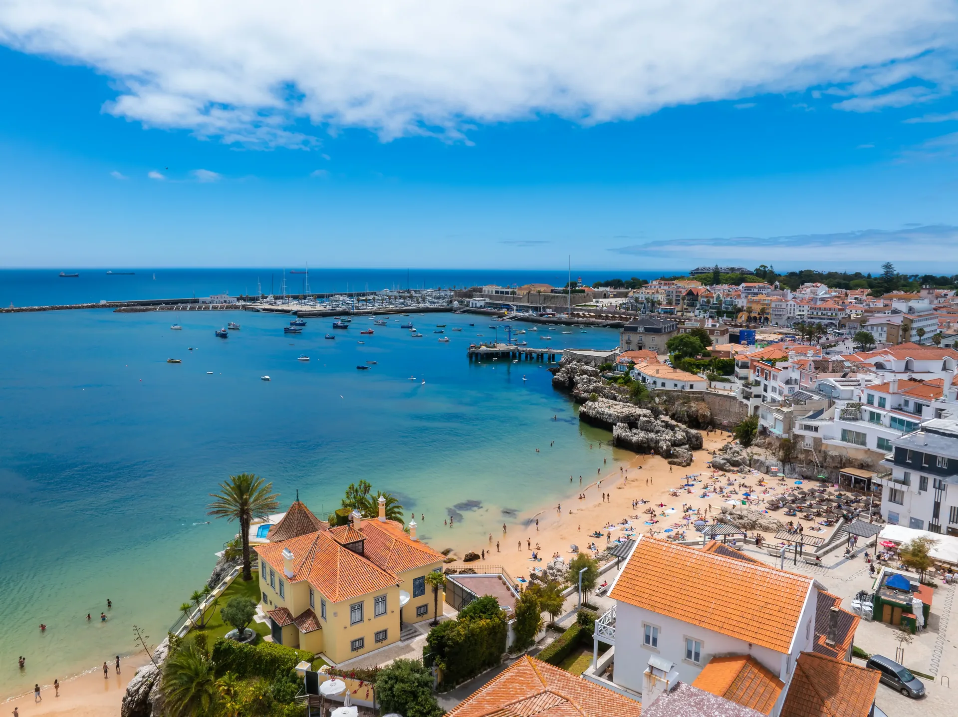 The Atlantic seafront promenade and old town of Cascais — the historic fishing village and former royal retreat on the Estoril coast, 30 kilometres west of Lisbon, with cobblestone streets, seafood restaurants, and the Fort of Our Lady of Light