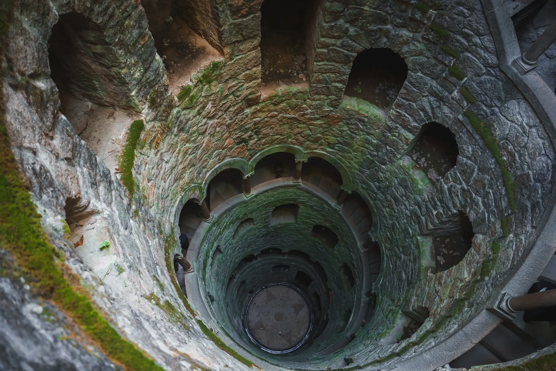 The Initiation Well at Quinta da Regaleira in Sintra — a nine-level spiral staircase descending 27 metres underground, lined with Templar and Masonic symbolism, one of the most extraordinary architectural secrets in Portugal