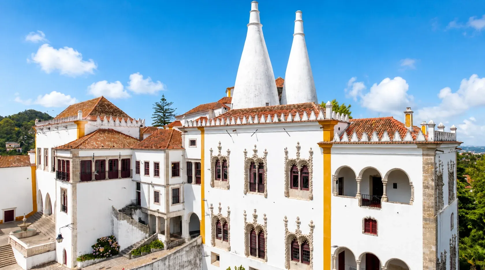 The twin conical chimneys of Sintra National Palace rising above the UNESCO hilltop town
